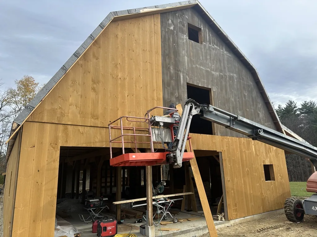 Barn exterior with the gray underlayer of siding showing