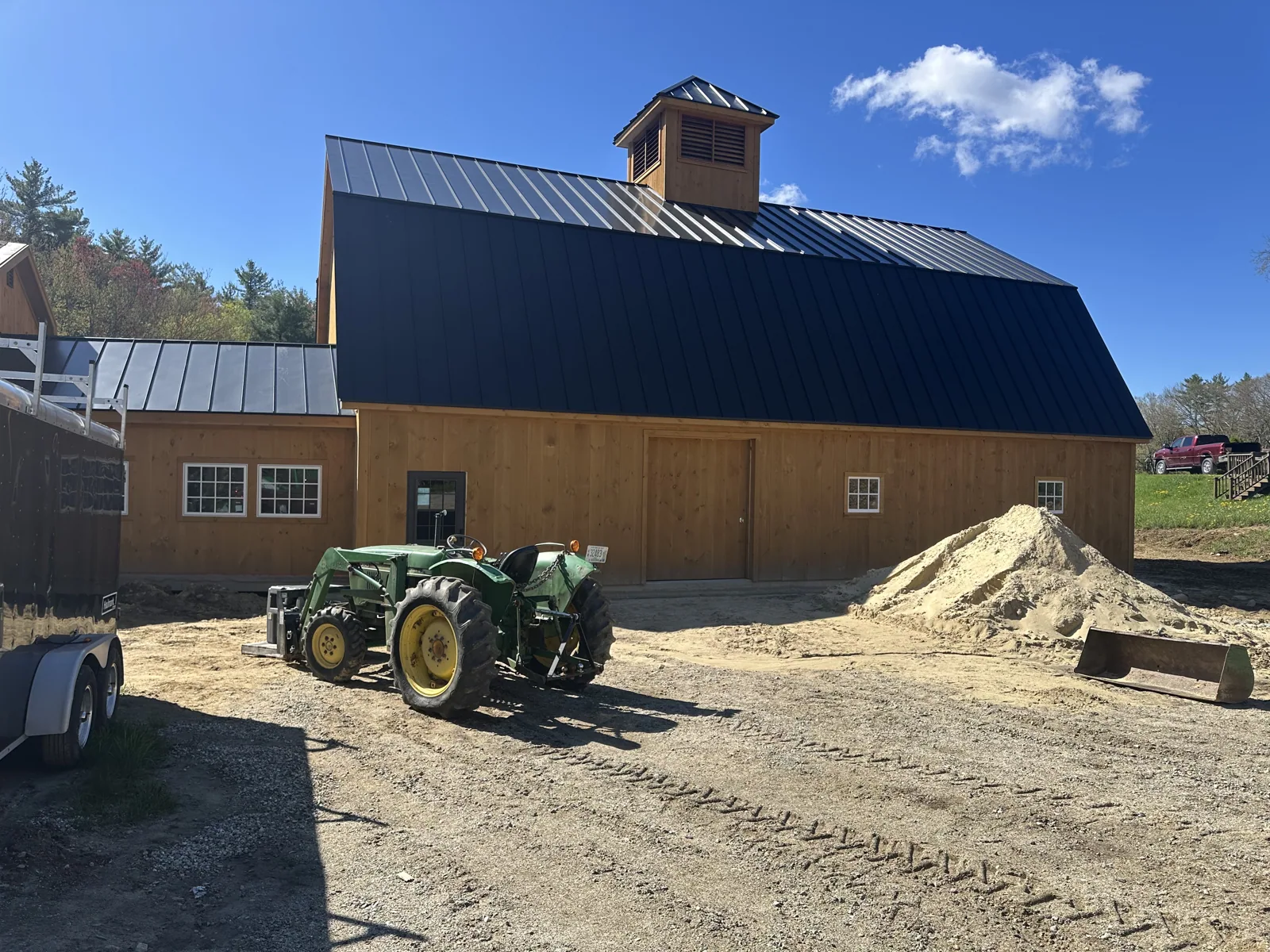 Barn nearing completion with the metal roof and landscaping