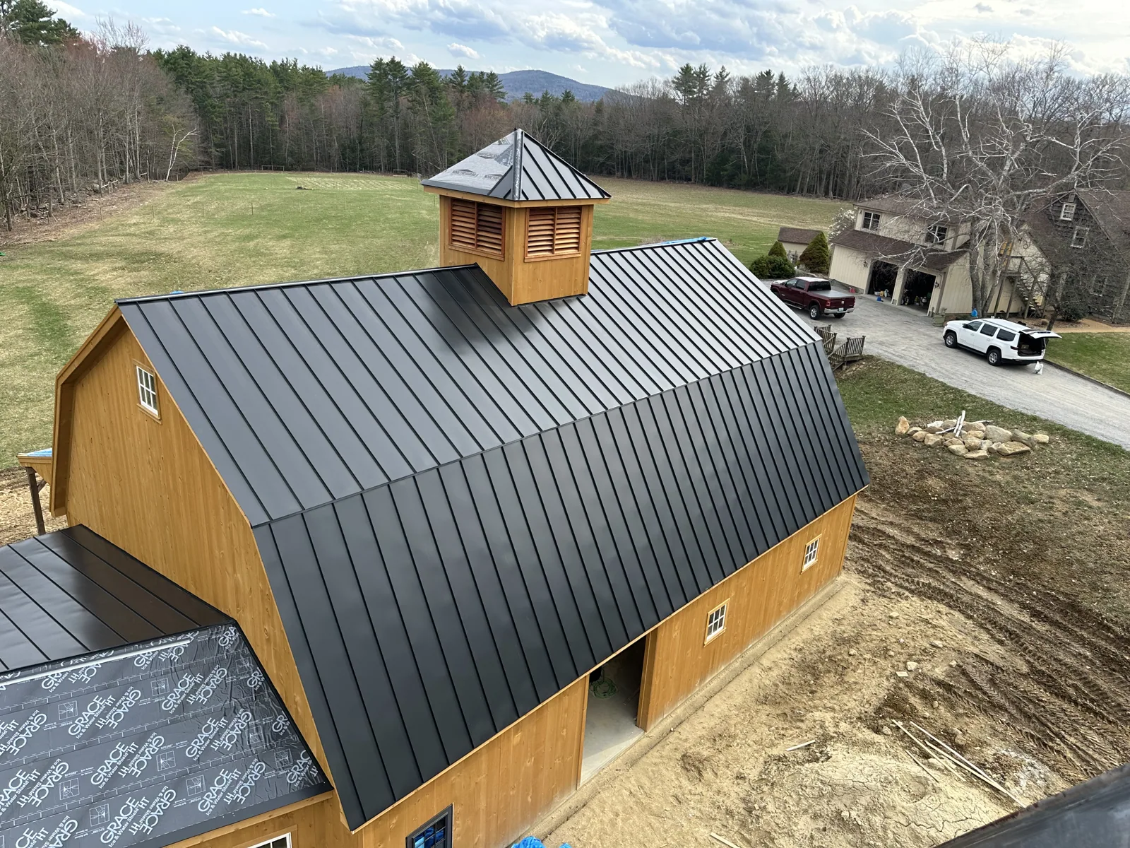 Finished timber-frame barn with a standing-seam metal roof