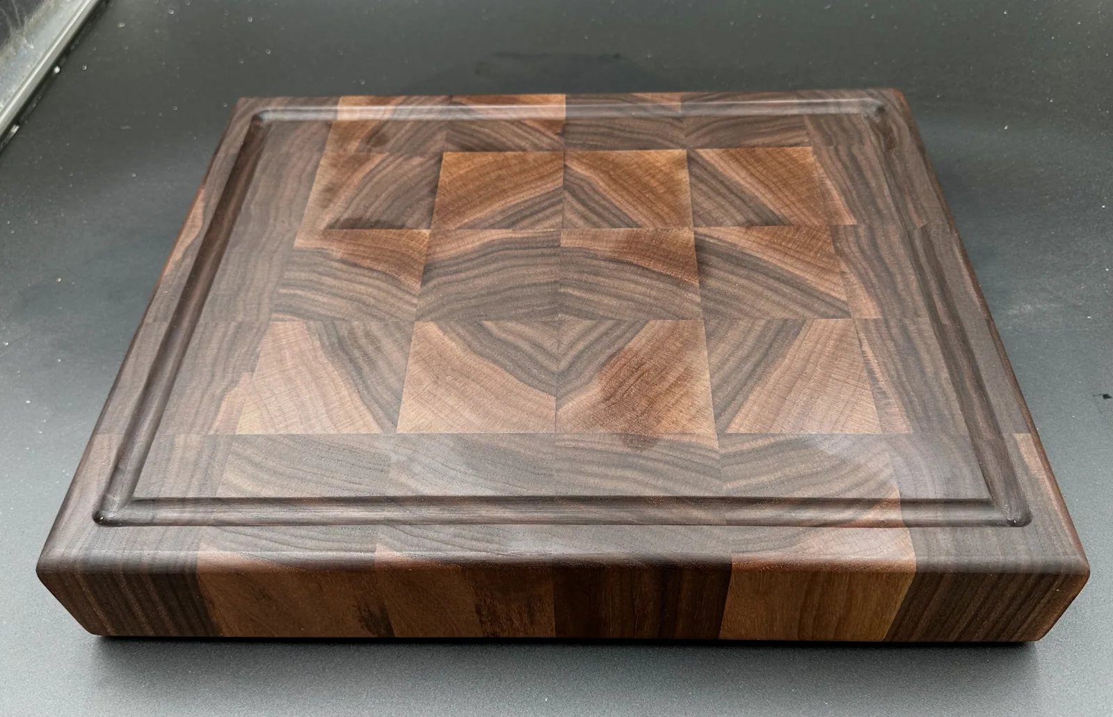 End-grain walnut cutting board, juice-groove side