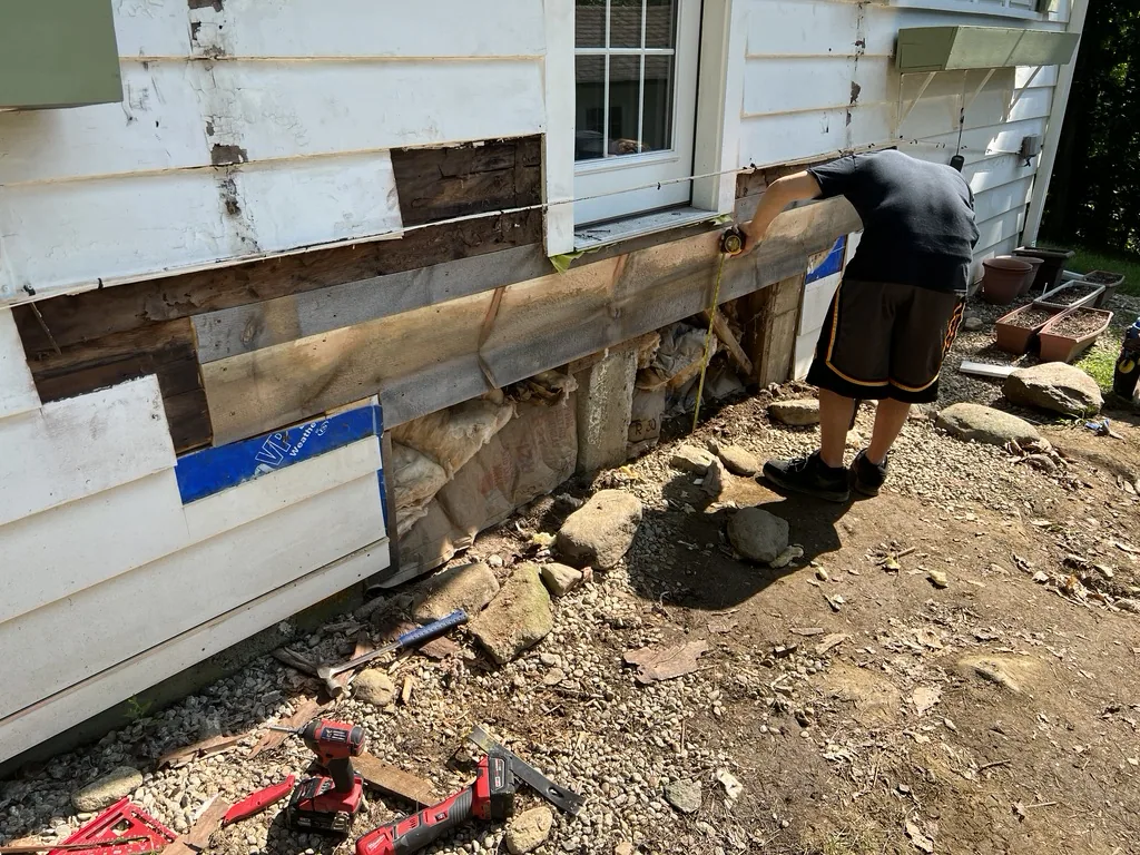 Old landing removed and rot on the house being repaired