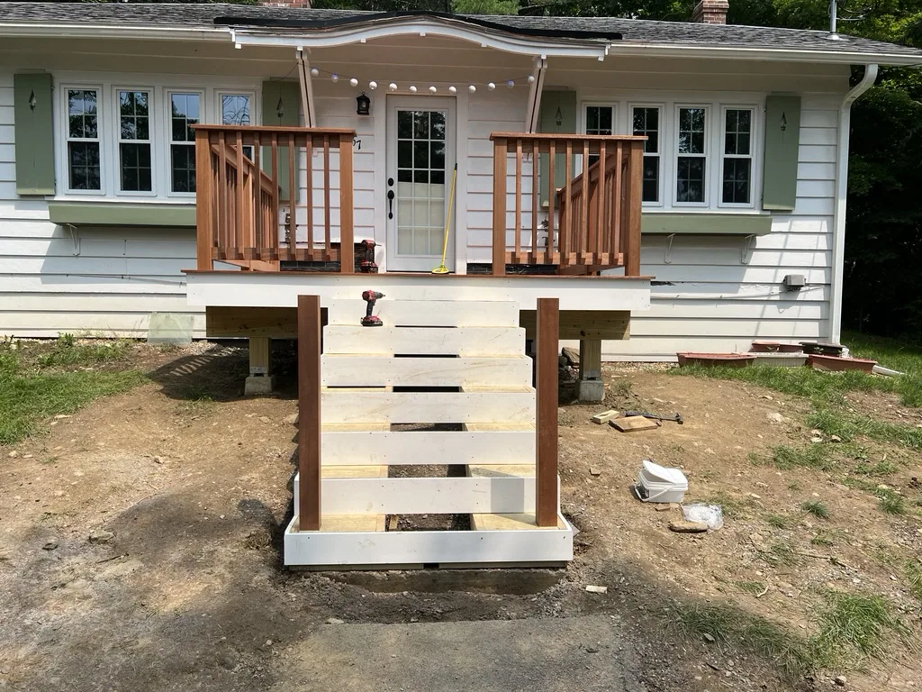 Mahogany stairs framed against the house
