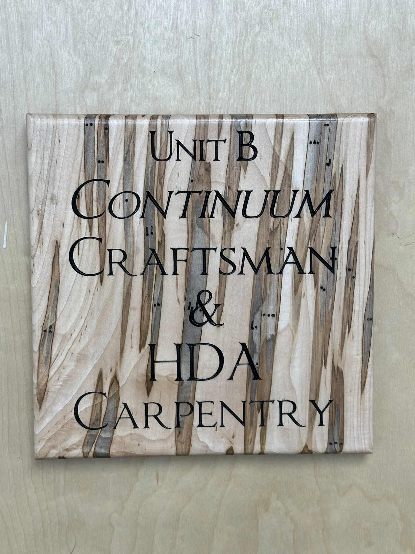 Ambrosia maple shop sign engraved for the Continuum Craftsman and HDA Carpentry partnership.
