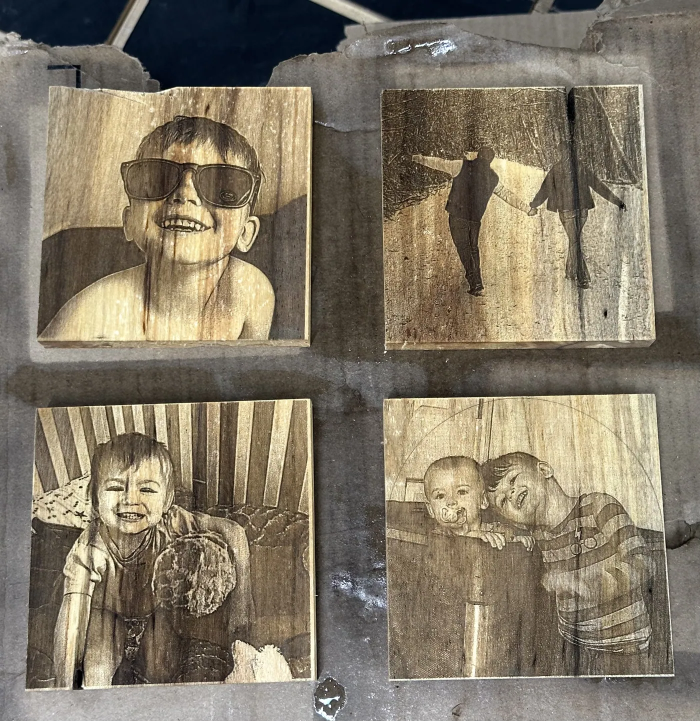 Family photographs burned into solid wood blocks in soft sepia tone.