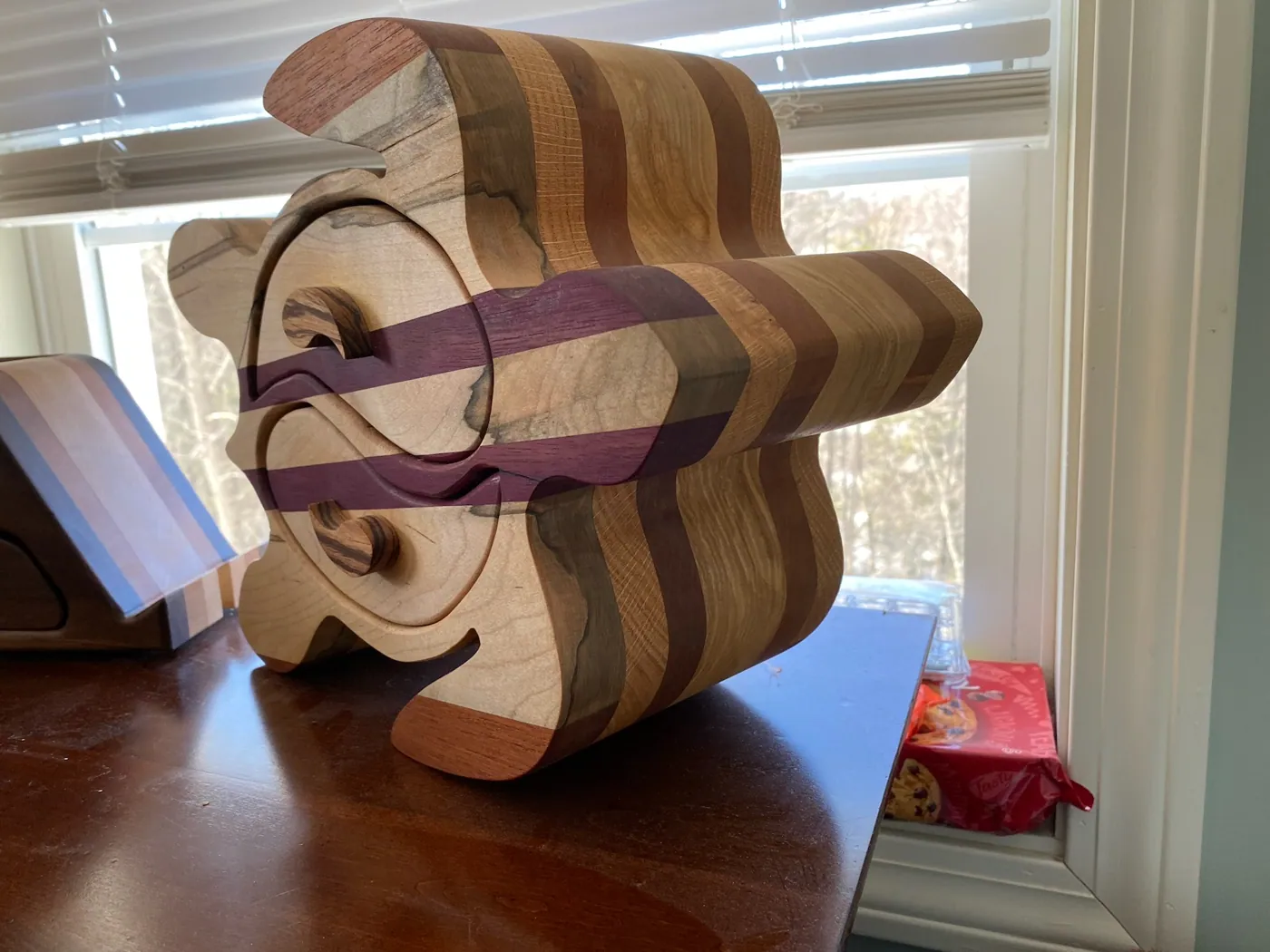Turtle-shaped keepsake box in striped hardwoods and purpleheart, with curved swing-out drawers.