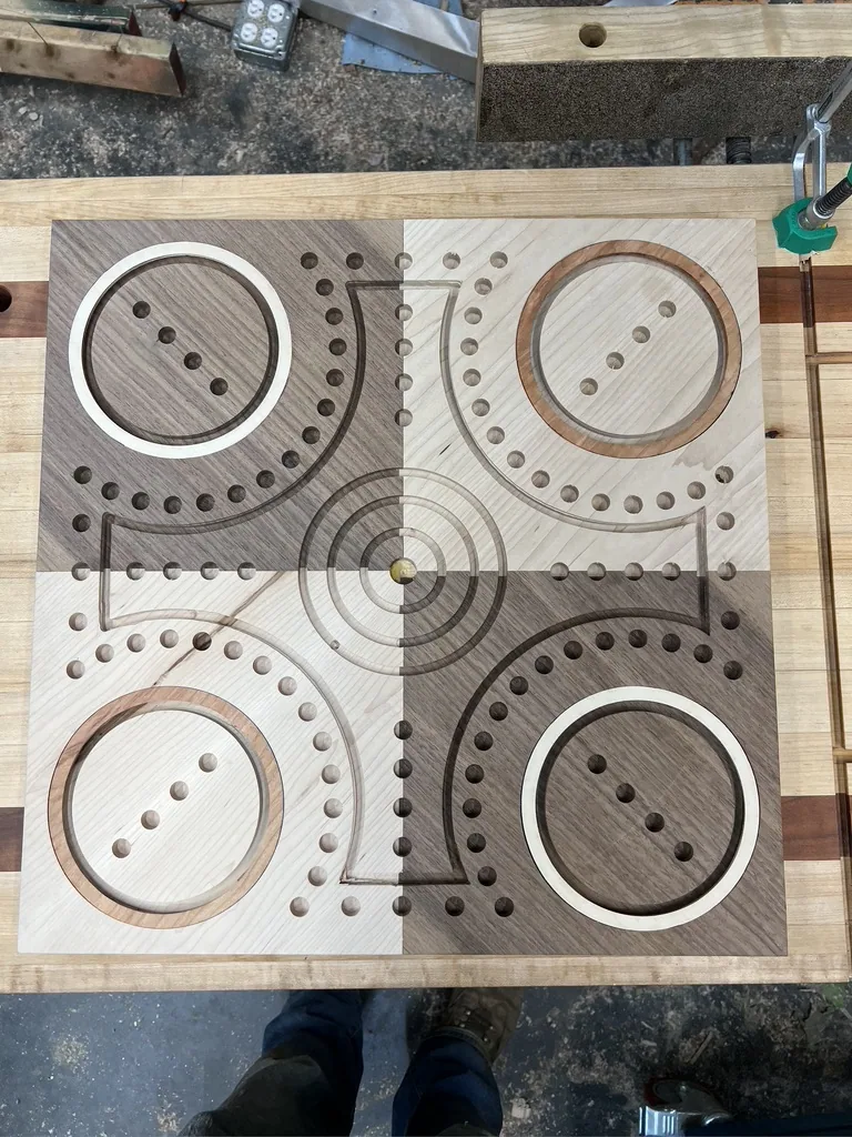 Playing tracks and holes being routed into the board