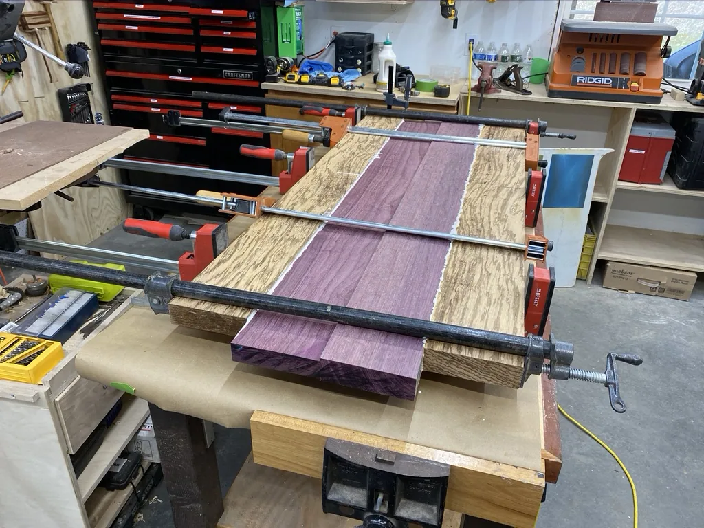 The glued tabletop clamped and worked flat on the bench