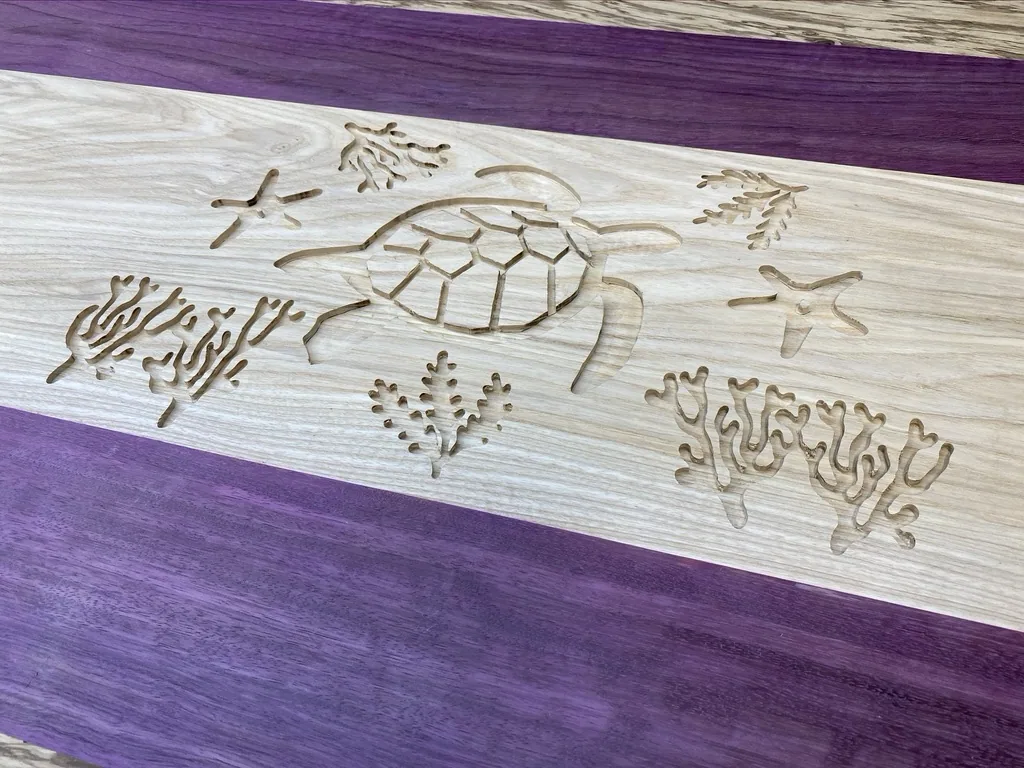 Close-up of the turtle and seaweed design carved into the ash before epoxy