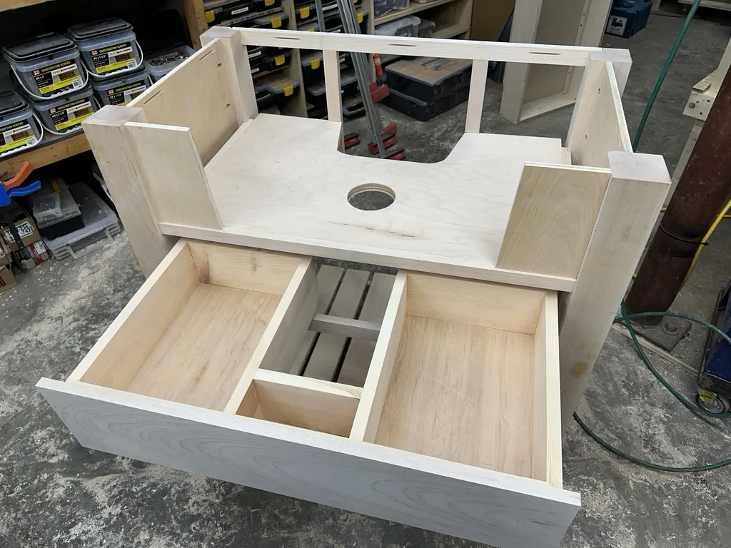 Assembled vanity frame with the sink opening and the drawer pulled out