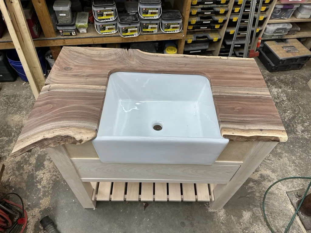 Live-edge walnut top fitted over the sink