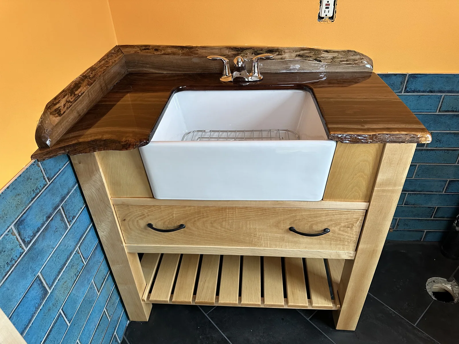 Maple and walnut vanity with a porcelain farmhouse sink, installed